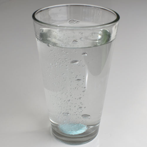 Drop a tablet of Instant Plant Food in a glass of water or watering can, watch the tablet dissolve, and water your plants with the solution.