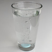 Load image into Gallery viewer, Drop a tablet of Instant Plant Food in a glass of water or watering can, watch the tablet dissolve, and water your plants with the solution.
